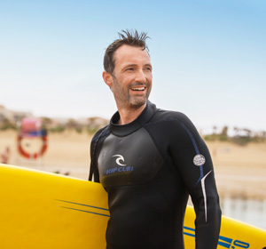 Ein Mann mit einem Surfboard.